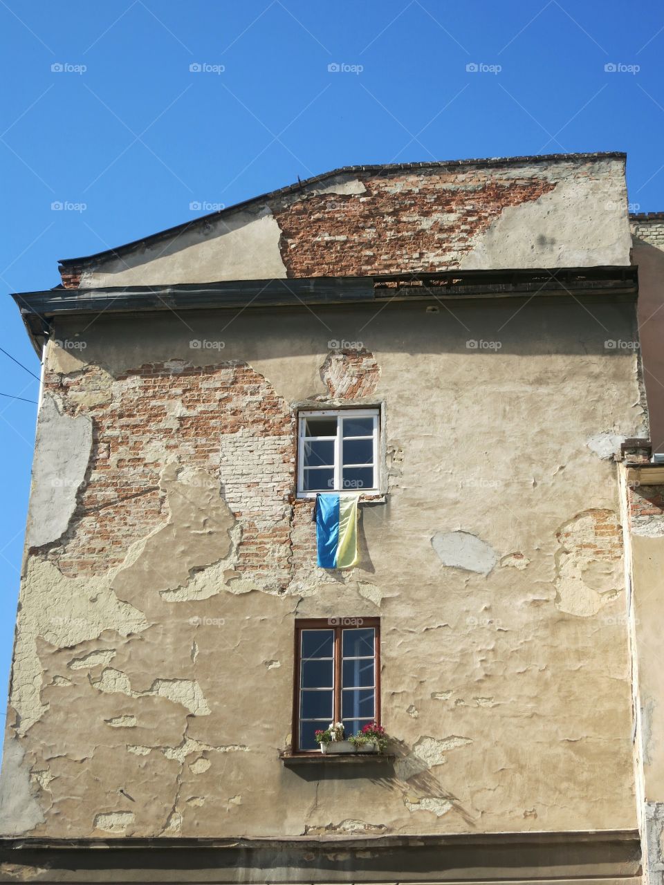 Flag by the window on old building