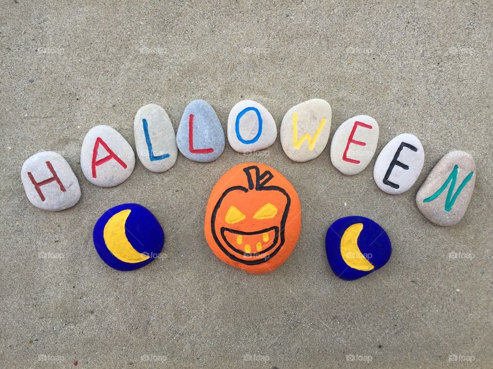 Halloween concept on stones. Carved and colored stones to celebrate Halloween