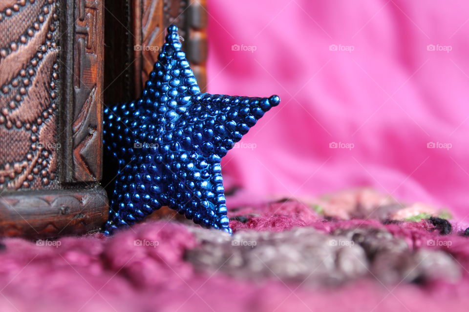 Close-up of blue star shape and wooden box