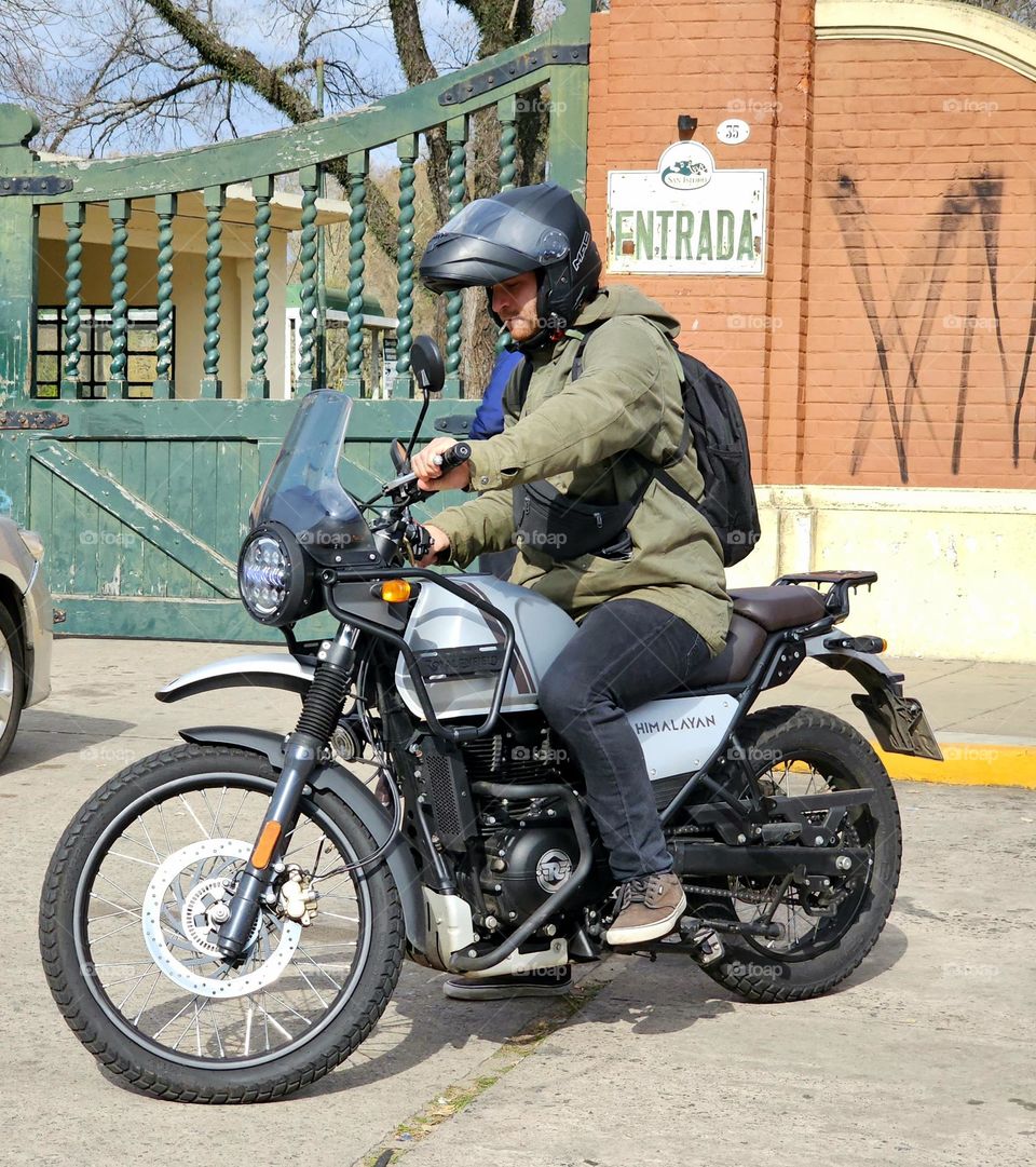 Motorbike rider, parking his motorbike safely