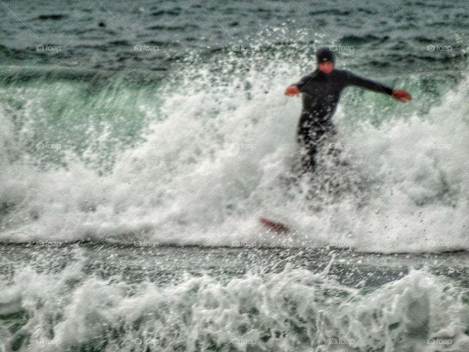 Surfer Riding A Wave Into Shore. Epic Surfing
