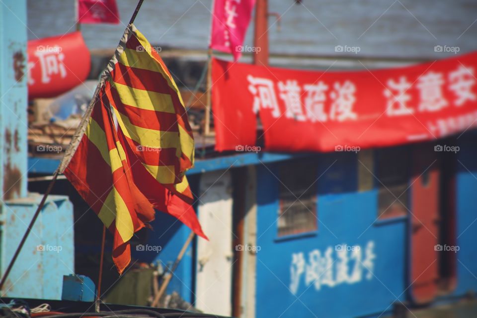A flag waving from a barge in Shanghai. 