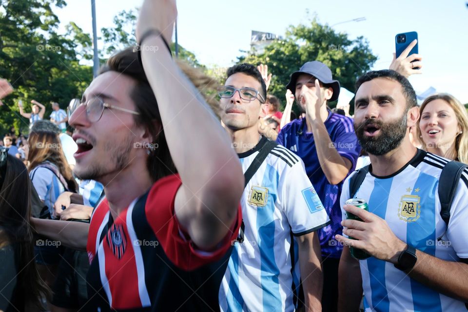 Buenos-Aires - 18.12.2022: Football fans of national team of Argentina in t-shirts on national team celebrating victory on the streets