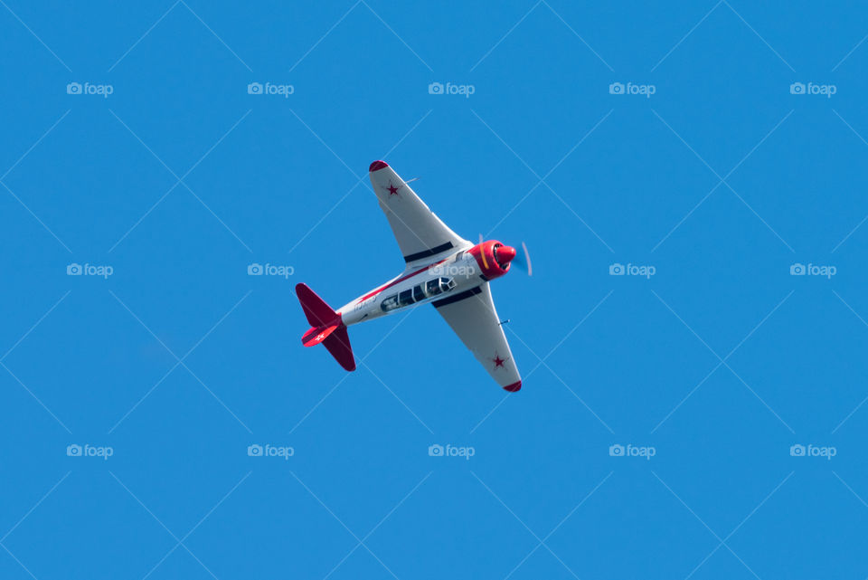 Helsinki, Finland - 9 June 2017: Yakovlev Yak-11 Soviet training aircraft flying upside down at the Kaivopuisto Air Show. This airplane was used by the Soviet Union and its Warsaw Pact allies from 1947 until 1962. It was also sold to many African and Asian countries by the Soviet Union.