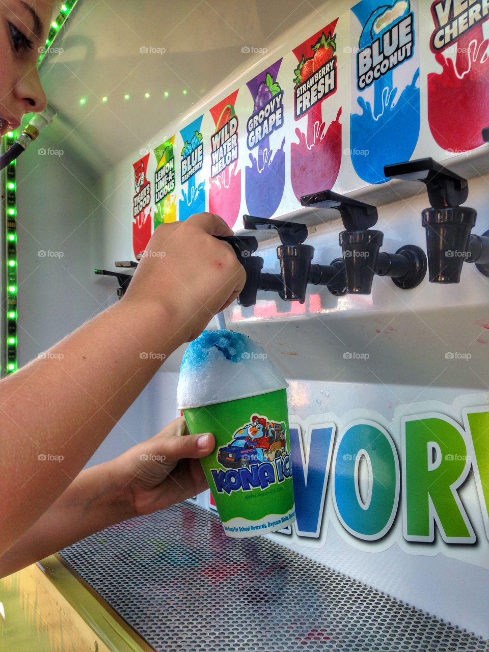 Sweet treat . Girl getting a Kona ice snow cone