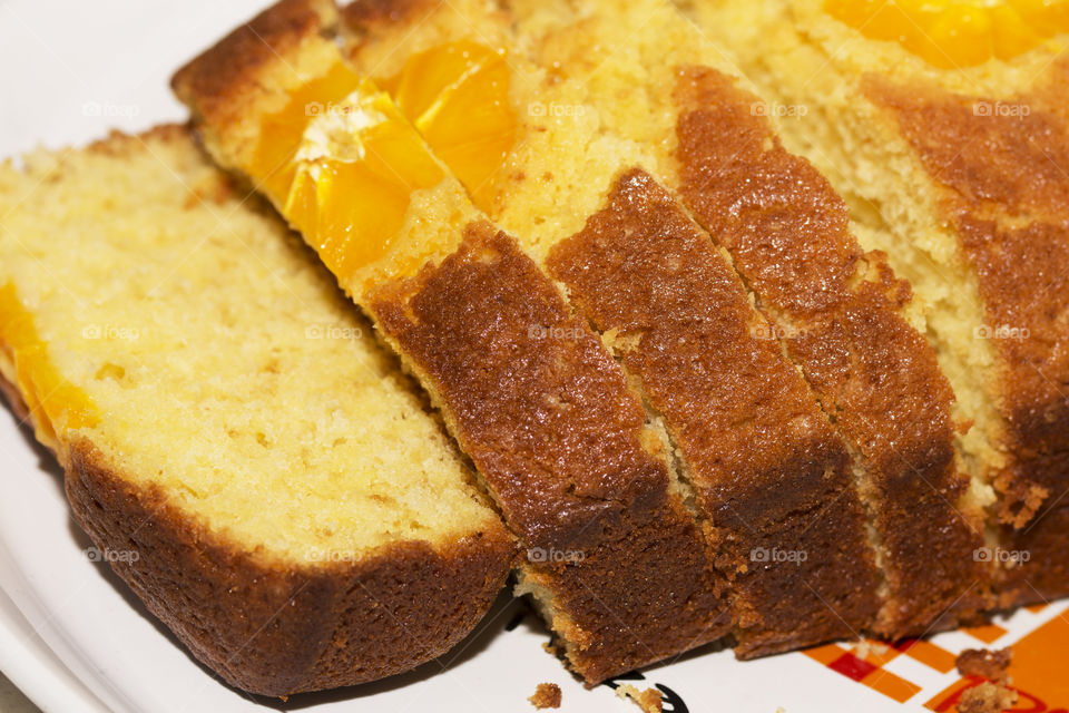 A bunch of delicious homemade orange bread loaves on a plate