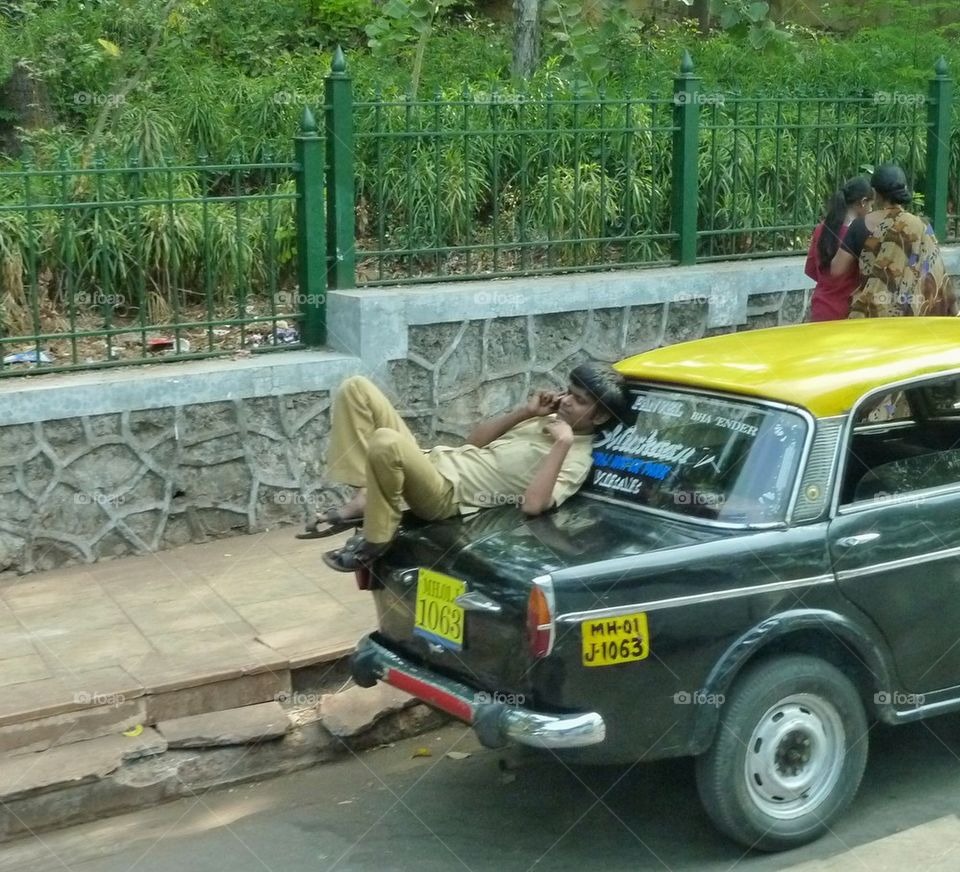 resting on a taxi, India