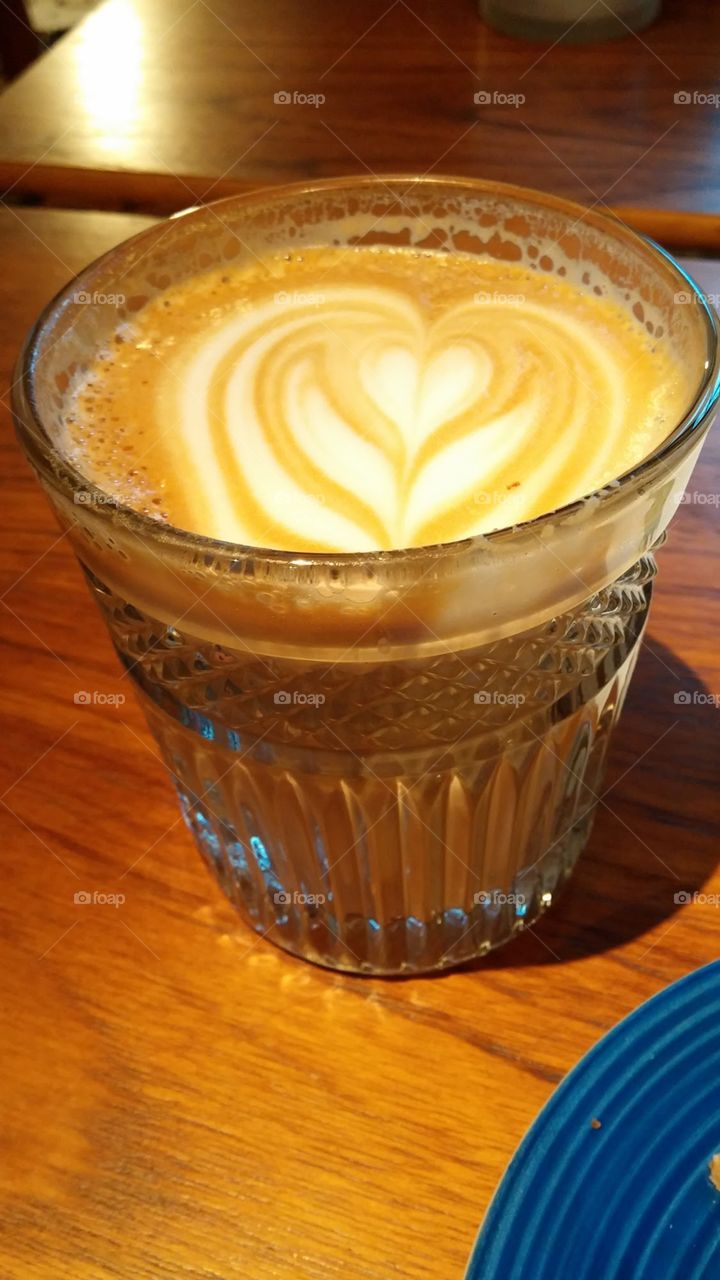 Full bodied oat latte with heart shaped design from Helsinki in a stunning crystal glass