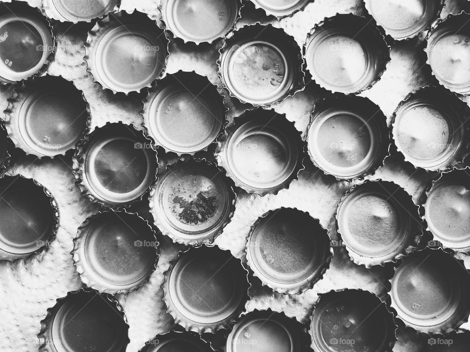 bottle caps on black and white