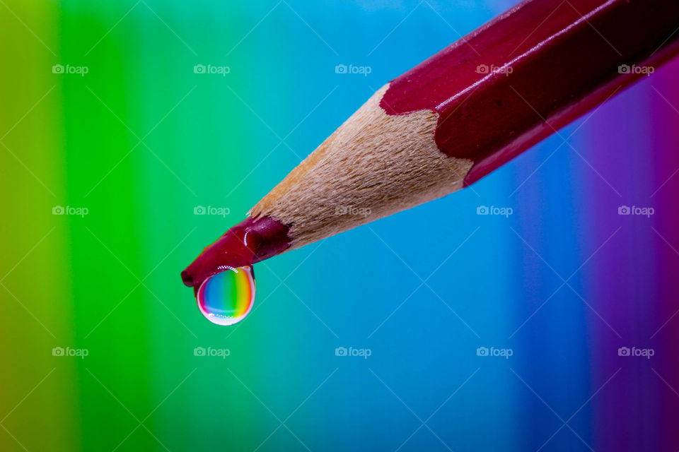 Red pencil with a drop of water