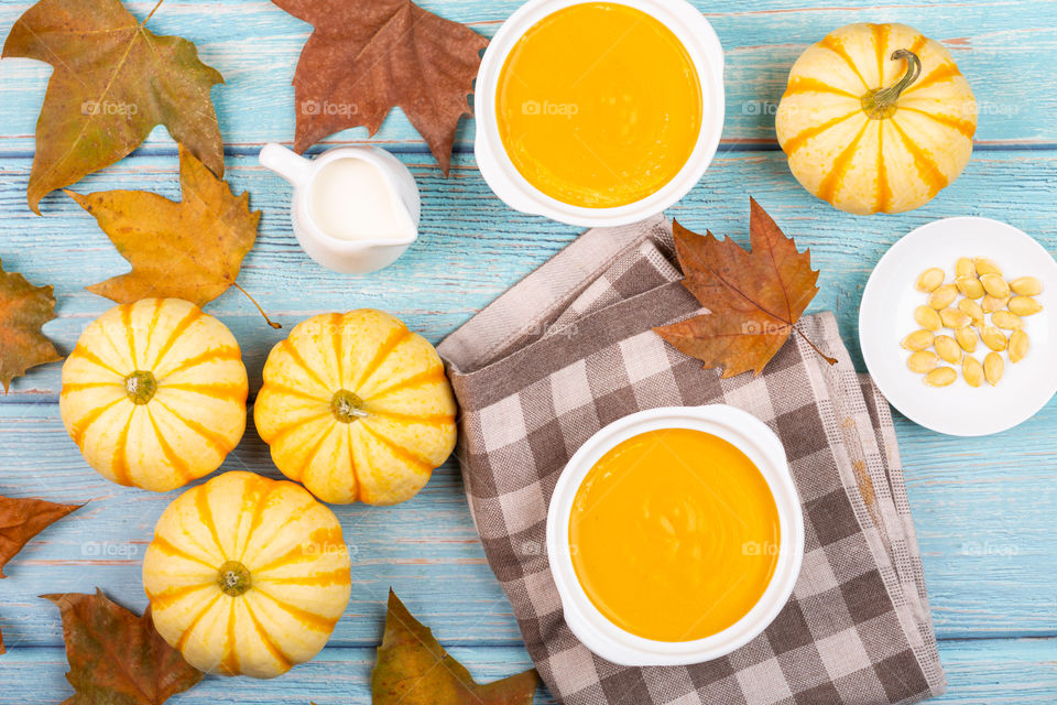 Pumpkin soup on blue background 