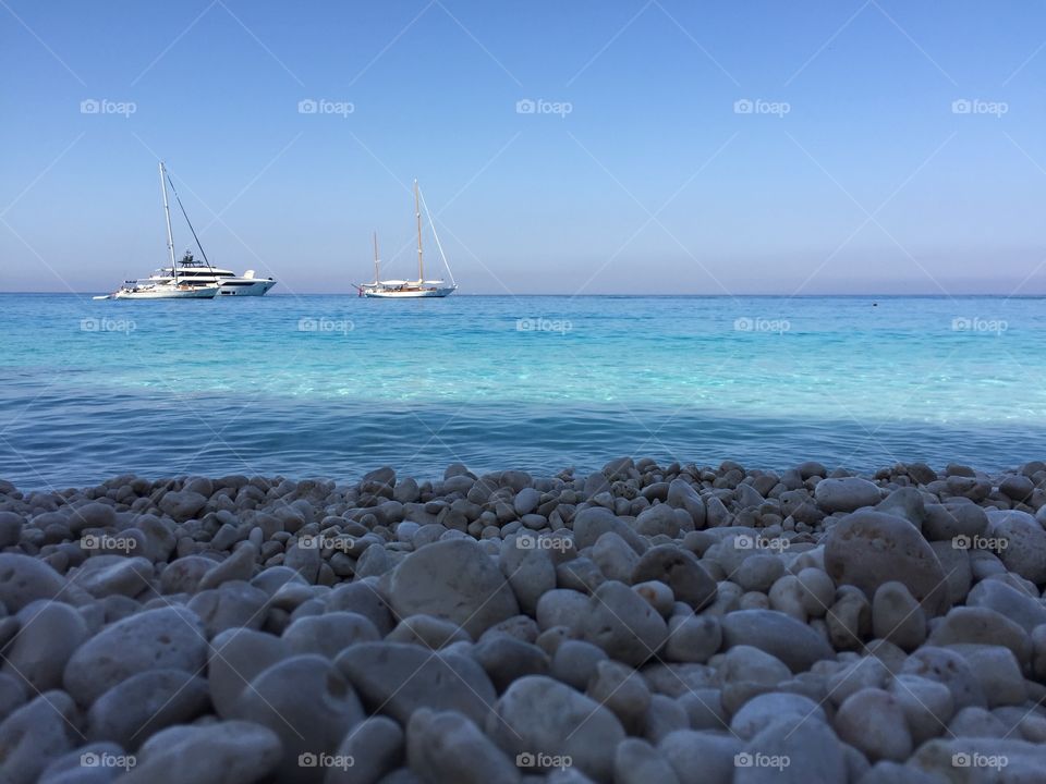 Rocky beach with azure sea color 