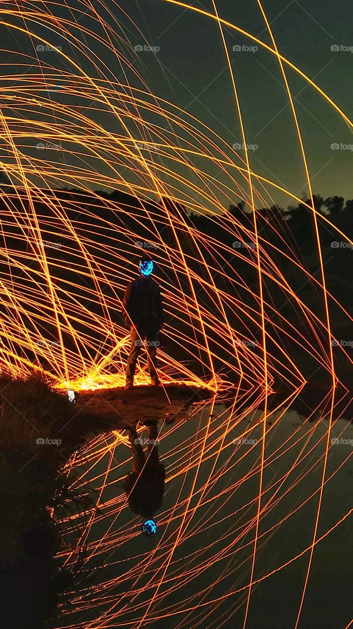 a man wearing a blue mask among the sparks