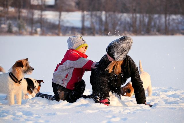 Brother playing with his sister in winter