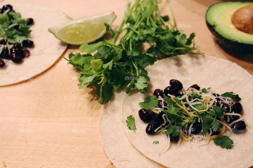 Taco meal preparation with fresh produce.