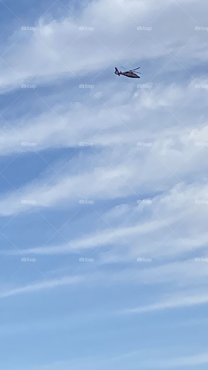 Big Helo In Motion flying High And Fast. Cloud Lines denote Weather Change for Future Leading Edge of Front. 