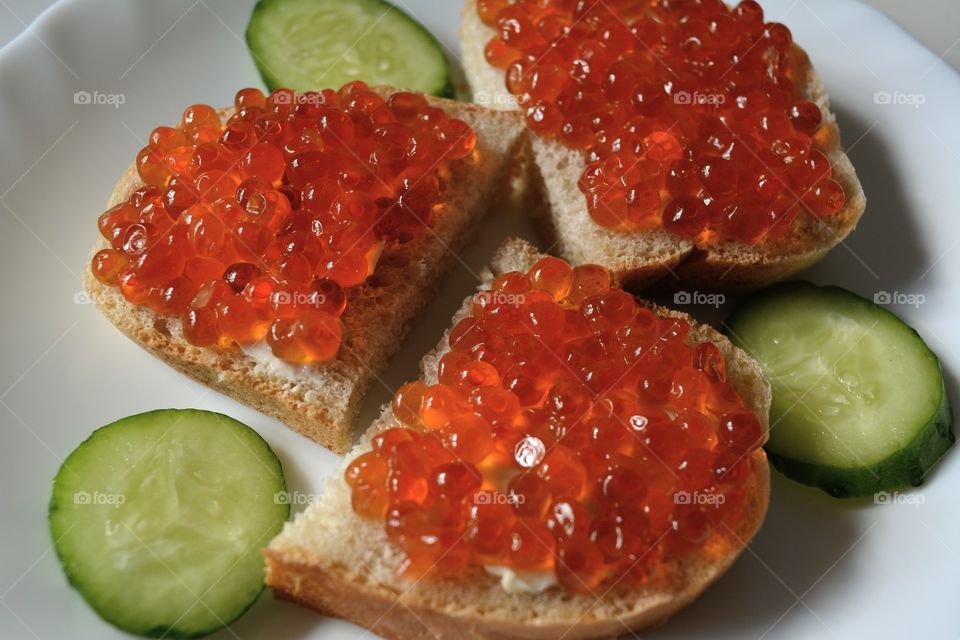 sandwiches with red caviar on a plate