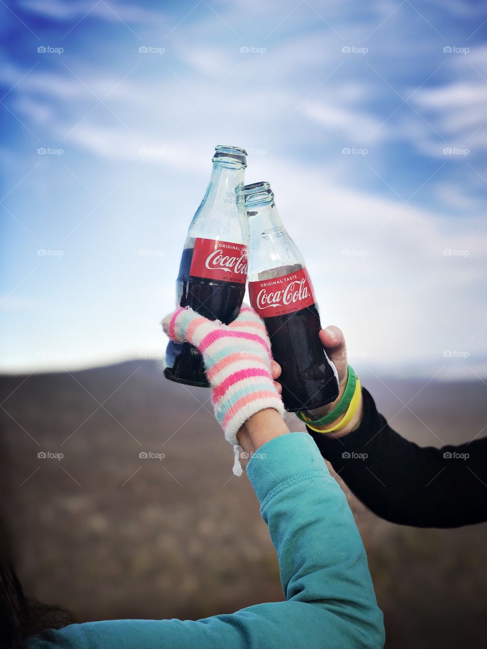Refreshing Coca-Cola after a hike up a mountain in the snow with friends. 