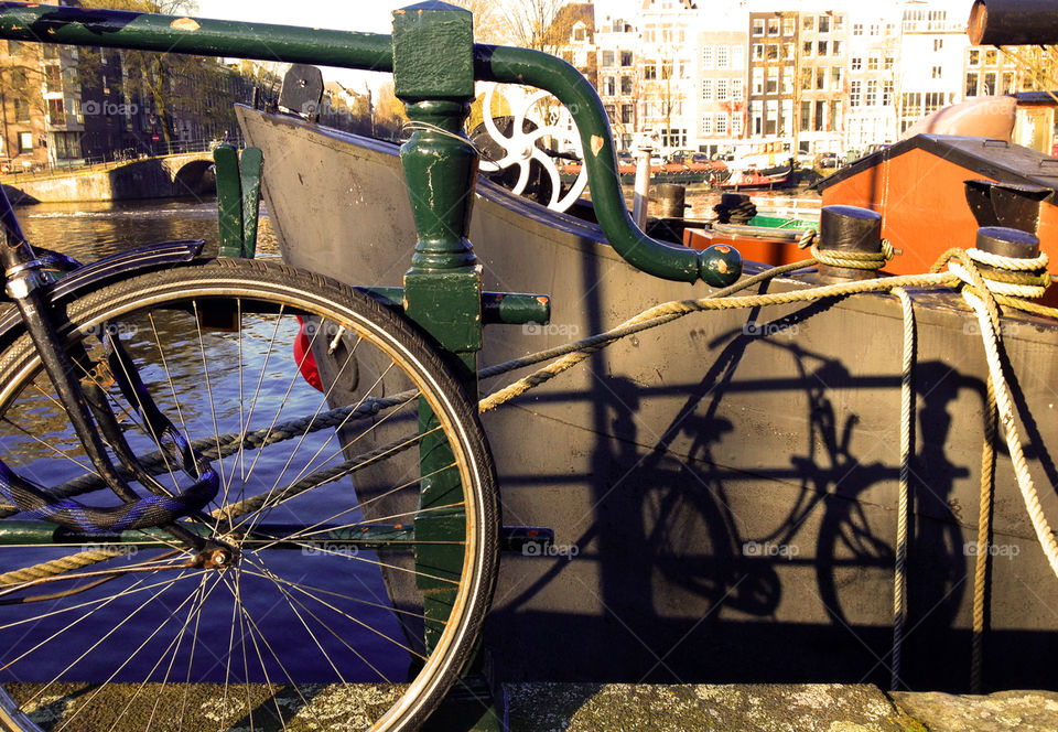 Shadow of a bicycle reflecting on a boat in Amsterdam, the Netherlands