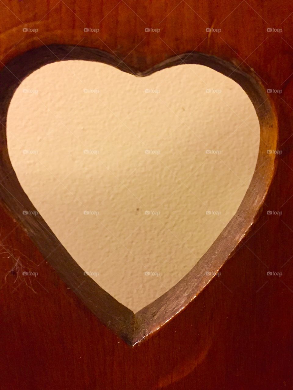 A heart cut out of wood.