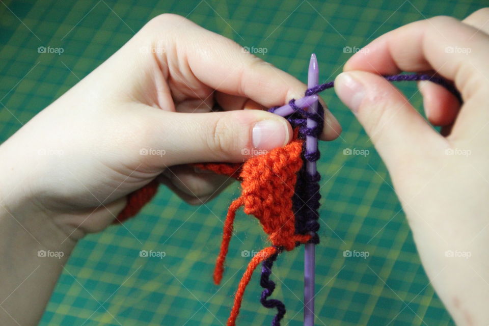 Close-up of a young woman knitting