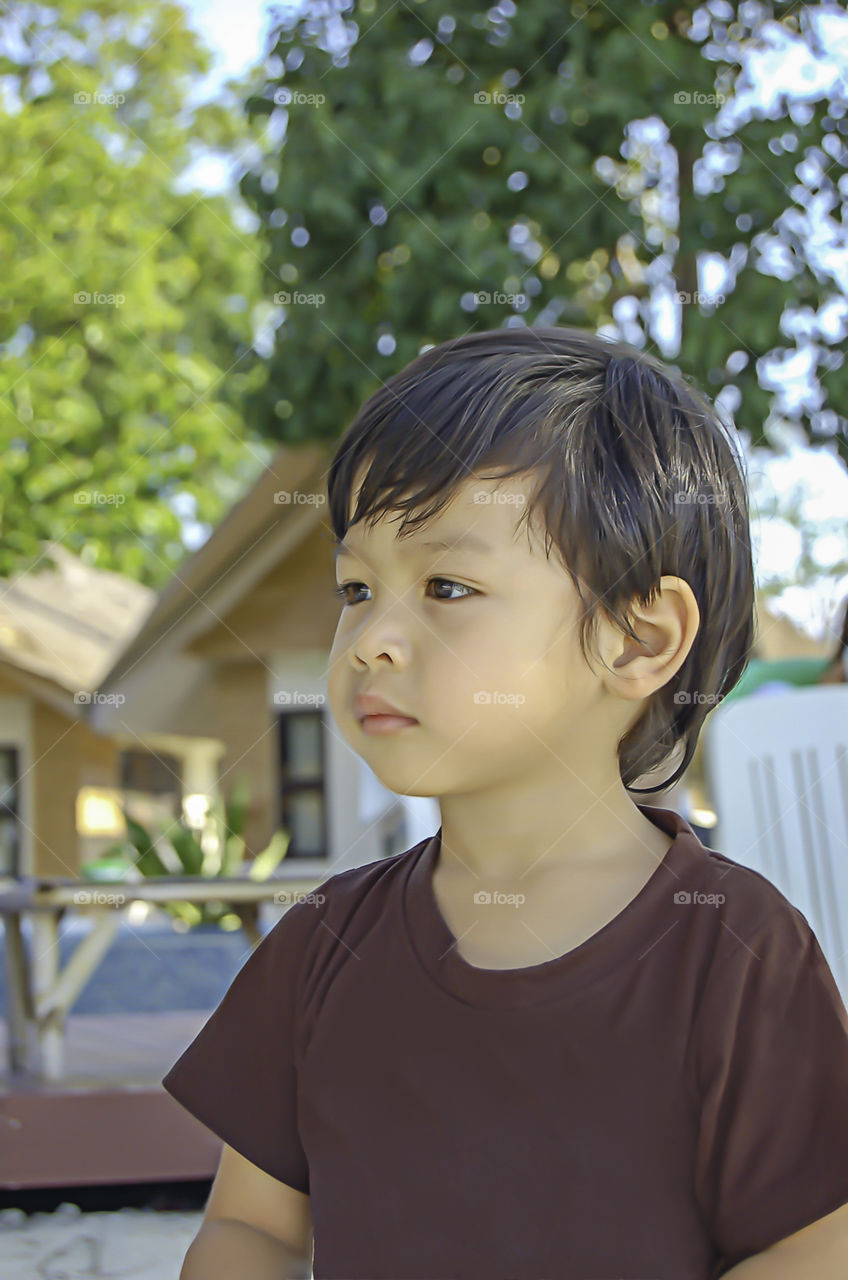 Portrait boy Sitting on the beach, Koh Lipe at Satun in Thailand.