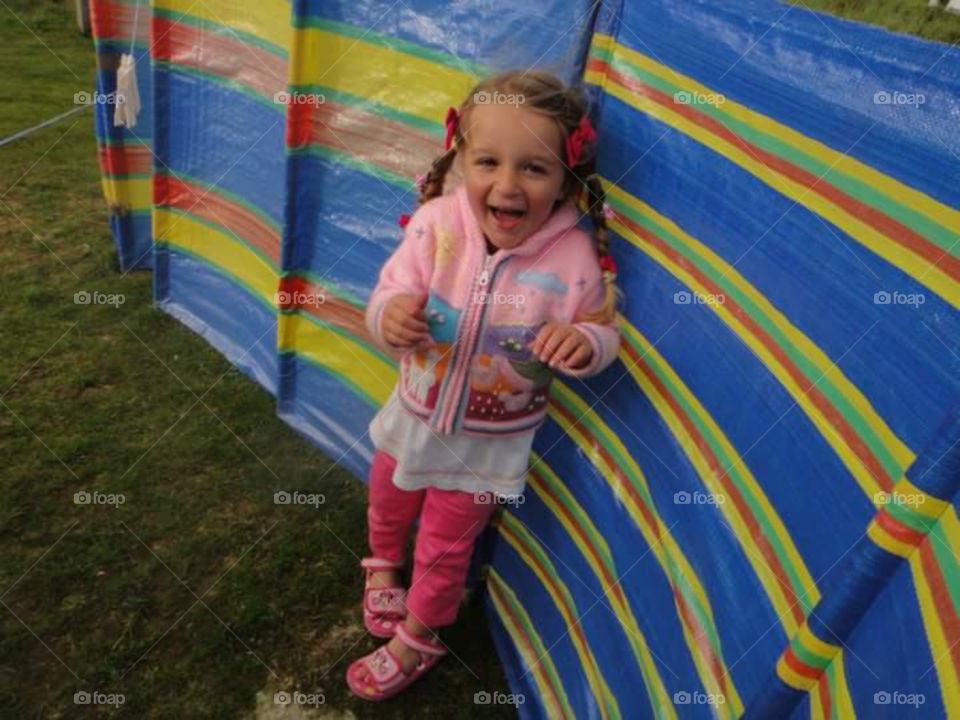 little girl playing hide and seek just been found.