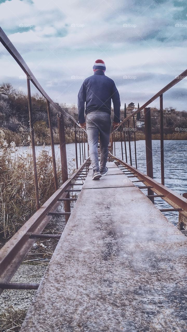 man on the bridge from behind