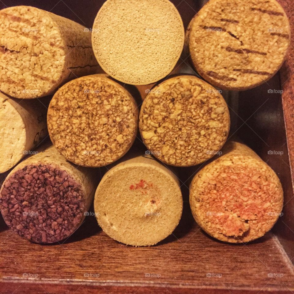 The ends of corks that have been stacked together. This is a close shot dominated by browns and tans.