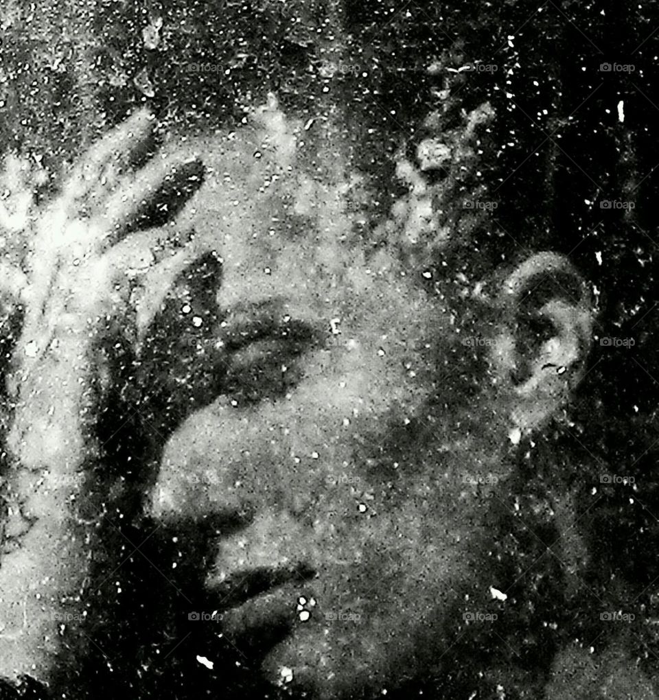 Black and white dirty reflection window and rain sadness and thoughts taken with a phone 