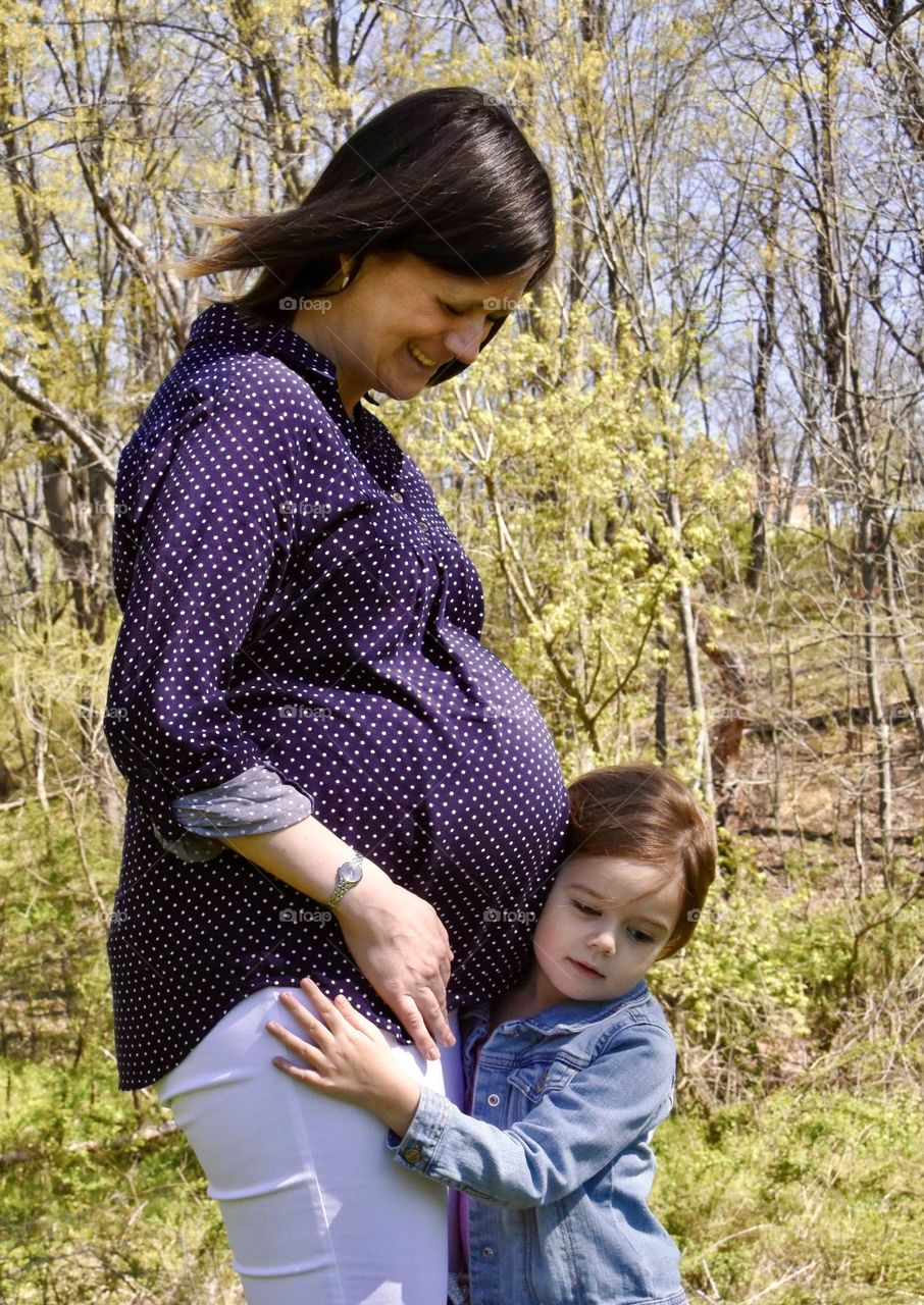 Expectant mother with her little girl