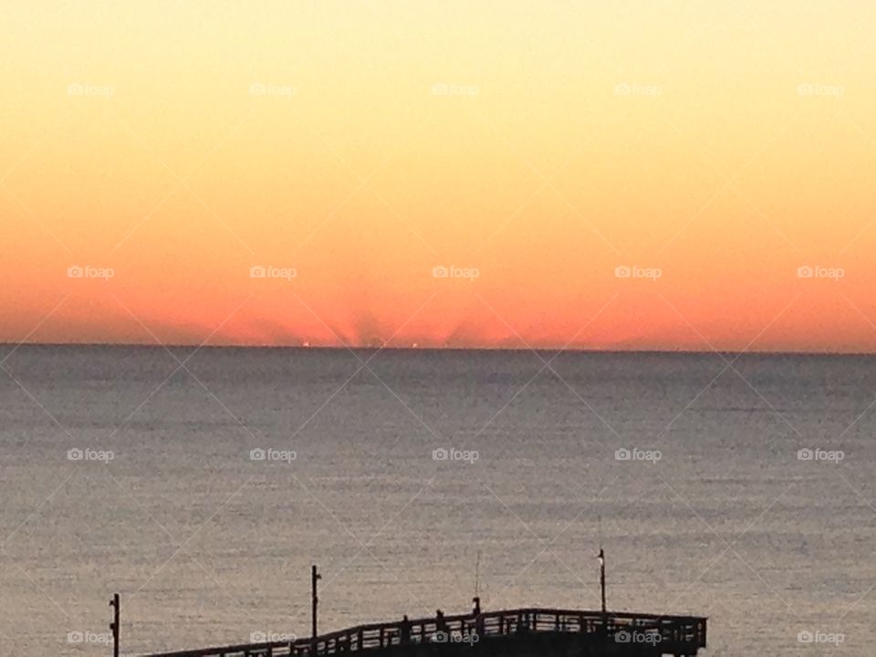 Orange pleasure. The sun coming out of the ocean at Myrtle beach South Carolina in October 2015
