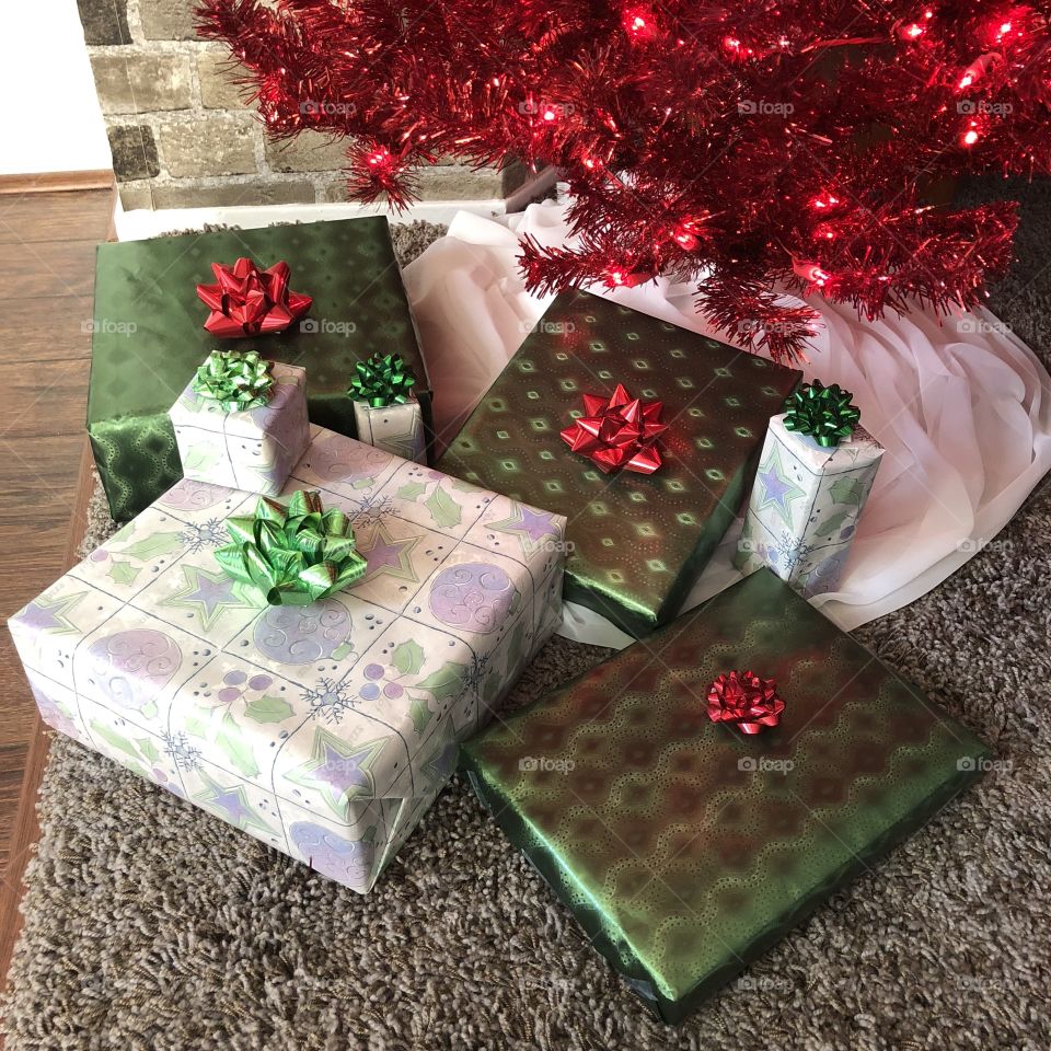 Christmas gifts under red Christmas tree