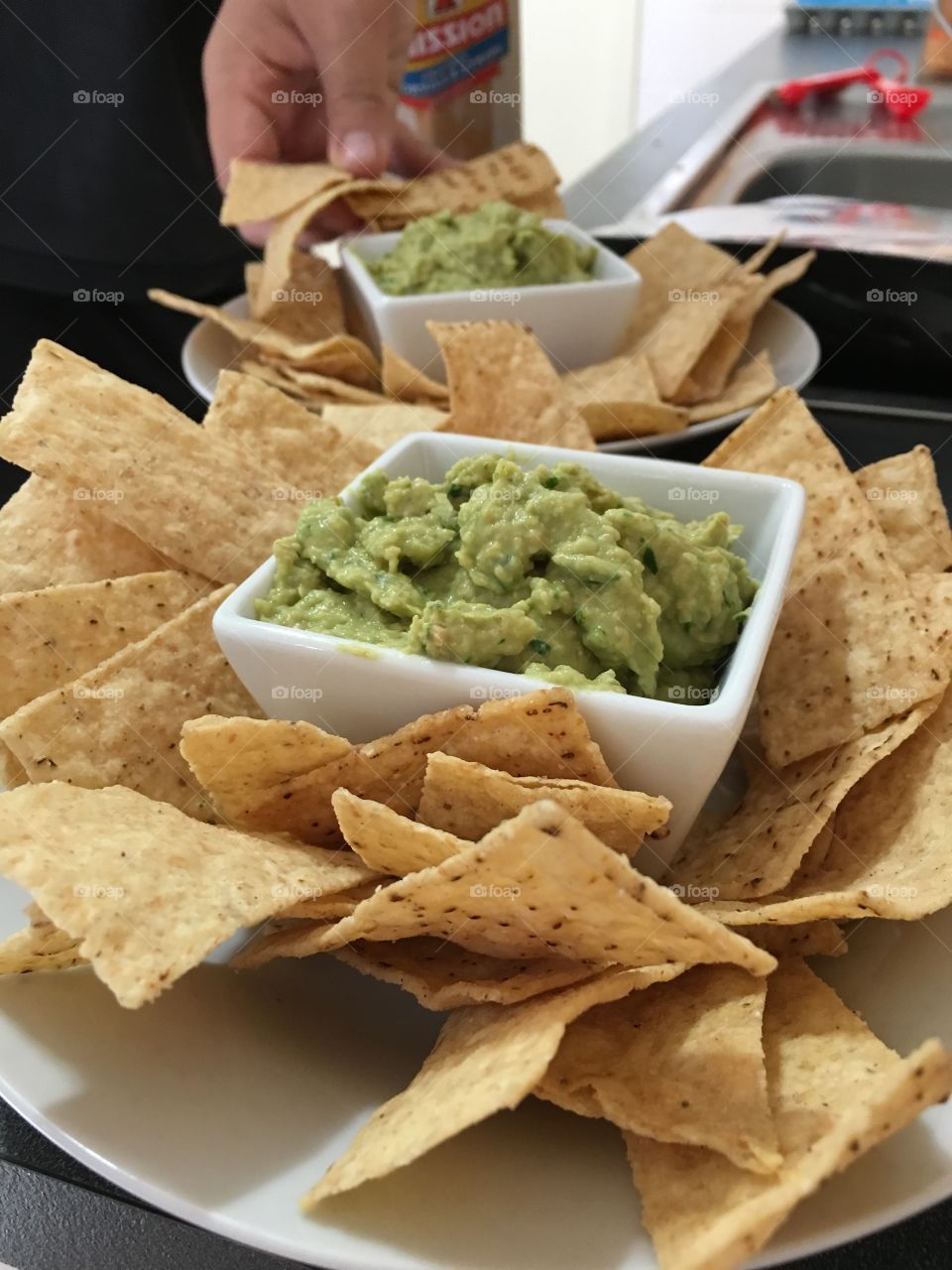 Spinach hummus dip and corn chips closeup
