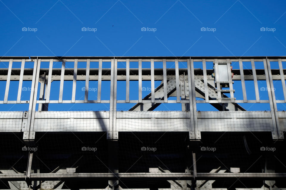 Low angle view of bridge against blue sky in Berlin, Germany.