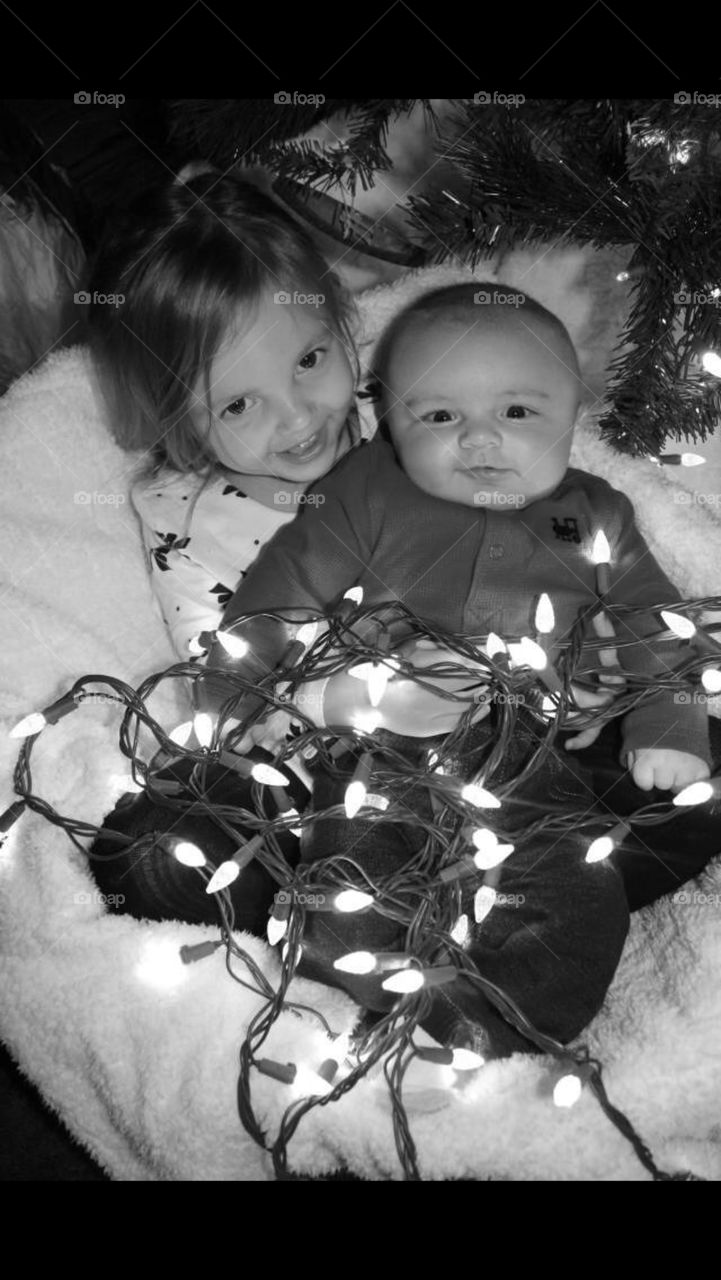 Kids wrapped in lights