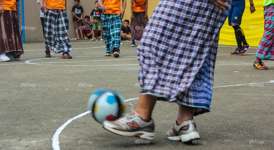 playing football using a sarong, playing football for fun.