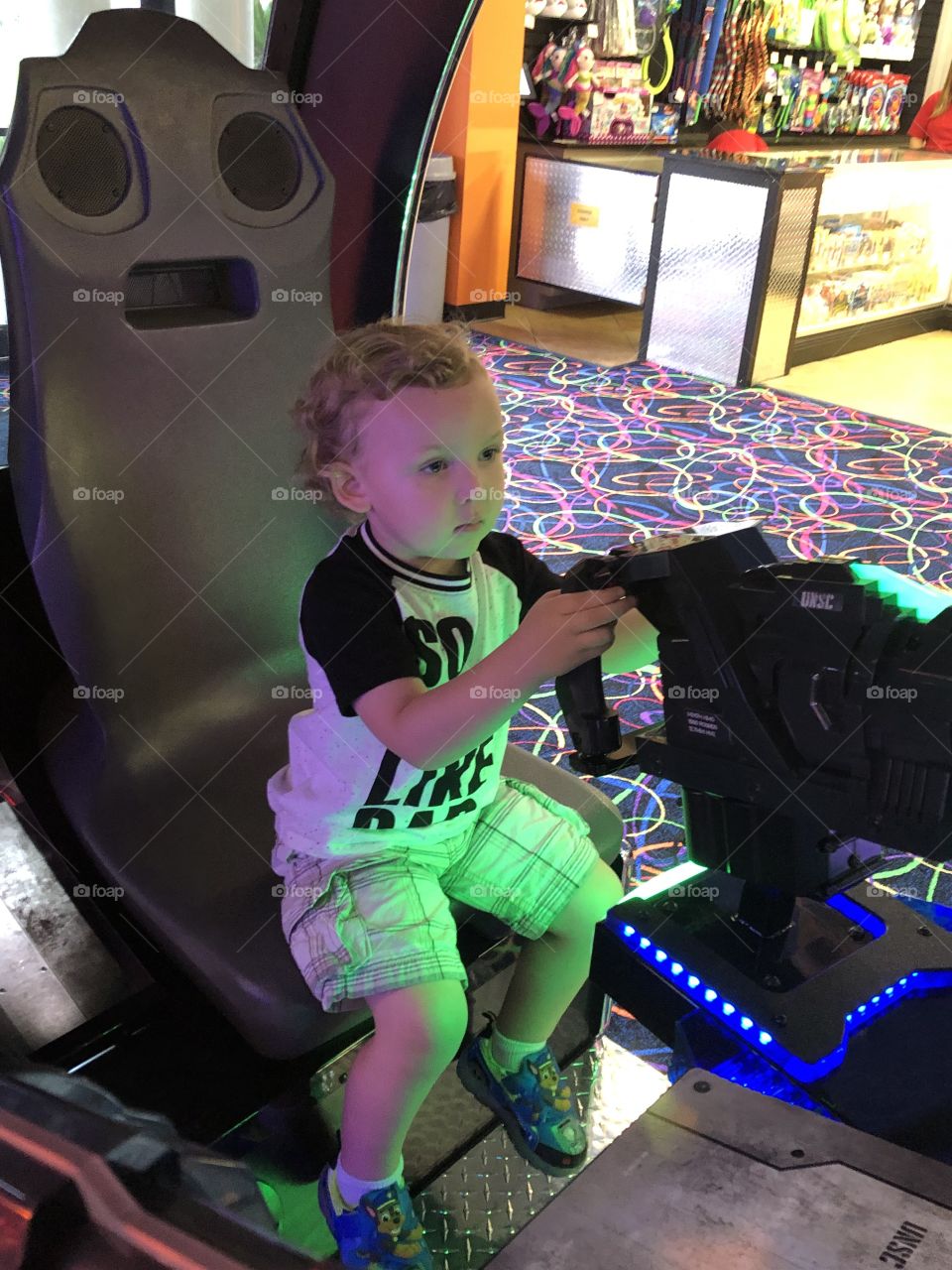 Toddler playing game at the arcade