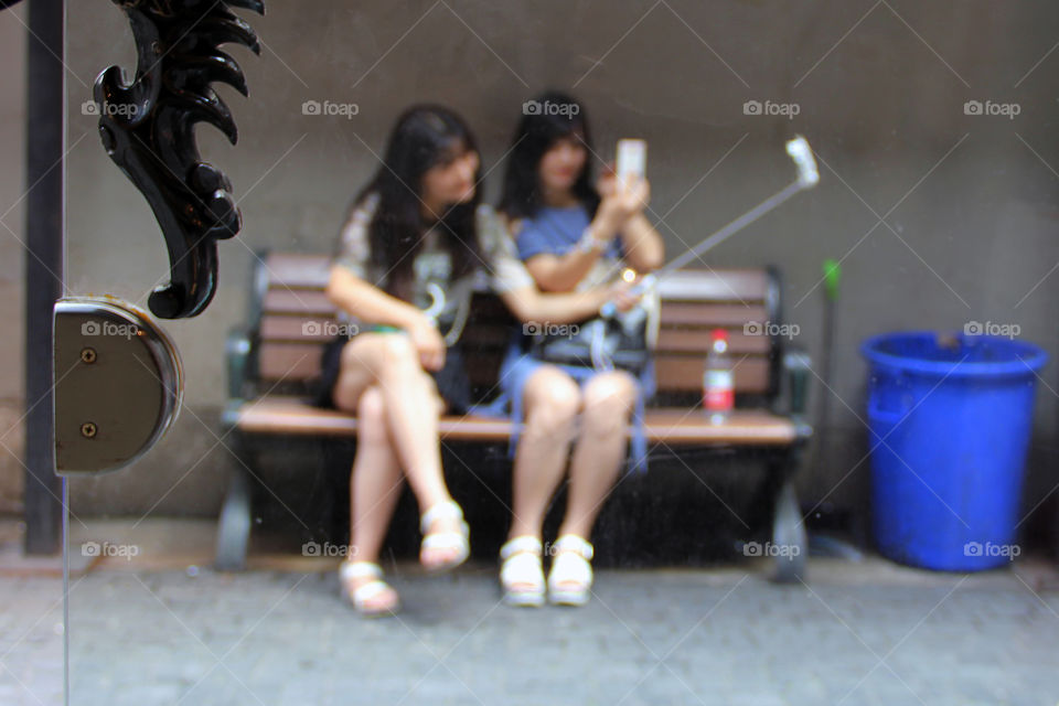 it's a selfie-world. Two girls were taking a selfie with a selfiestick. I thought a blurry photo of them would look nice, this is the result.