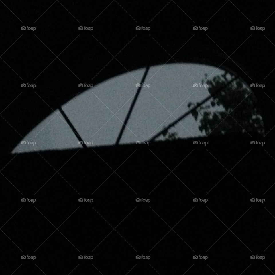 Nighttime, laying in bed looking up at my window during a thunderstorm 