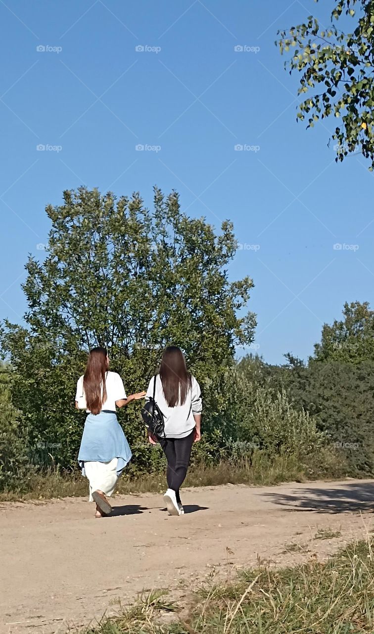 two womens friends walking outside