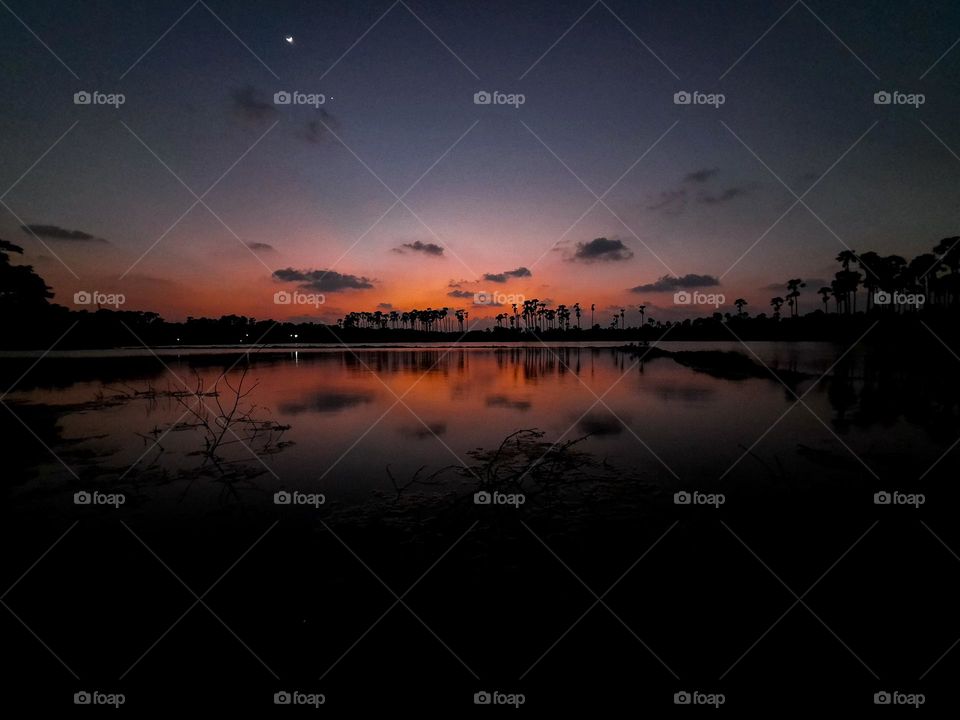 Beautiful sunset in the northern part of Sri lanka with palmyra trees in far end.