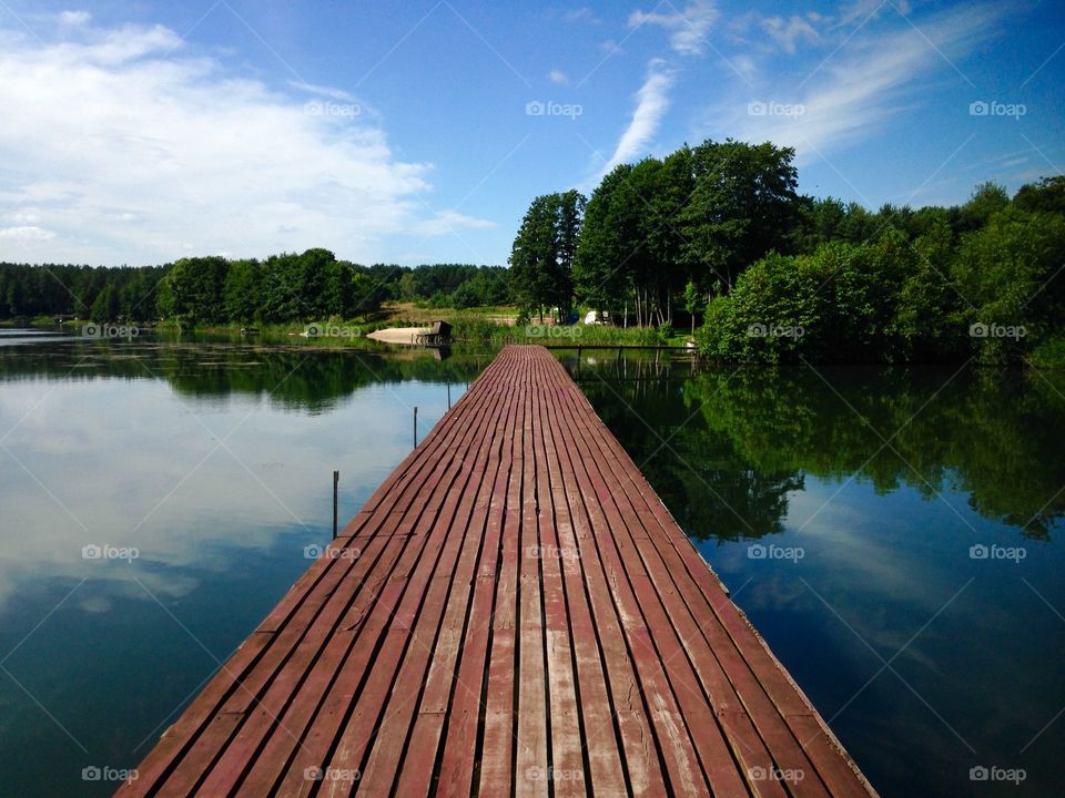 Wooden pier on the lake during summer weekend on the lake in Poland 