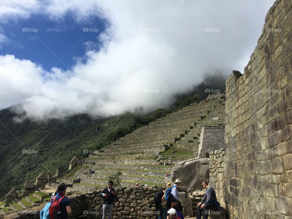 Machu Picchu ruins . Machu Picchu ruins in the clouds