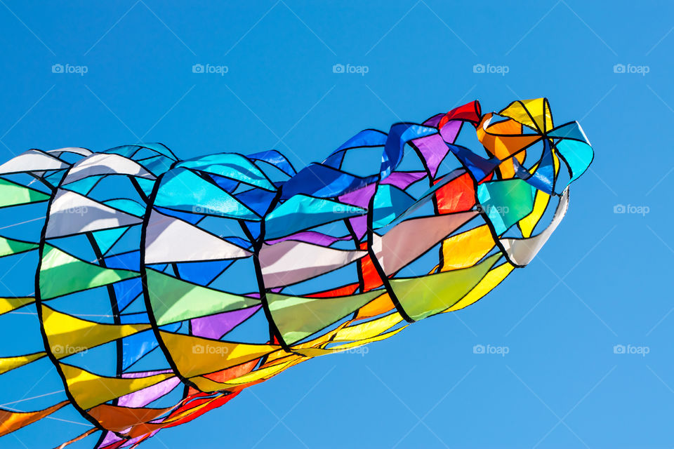 colorful kite dance with wind on clear blue sky