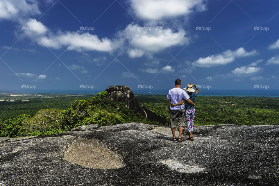 Couple looking into surrounding landscape with big stones
