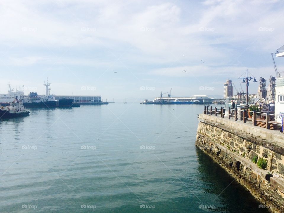 Scenic view of harbour entrance and stone wall at V&A Waterfront in the port city of Cape Town 