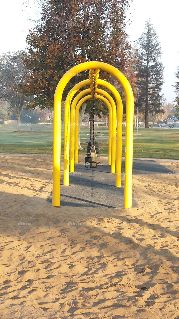 A set of swings sitting motionless