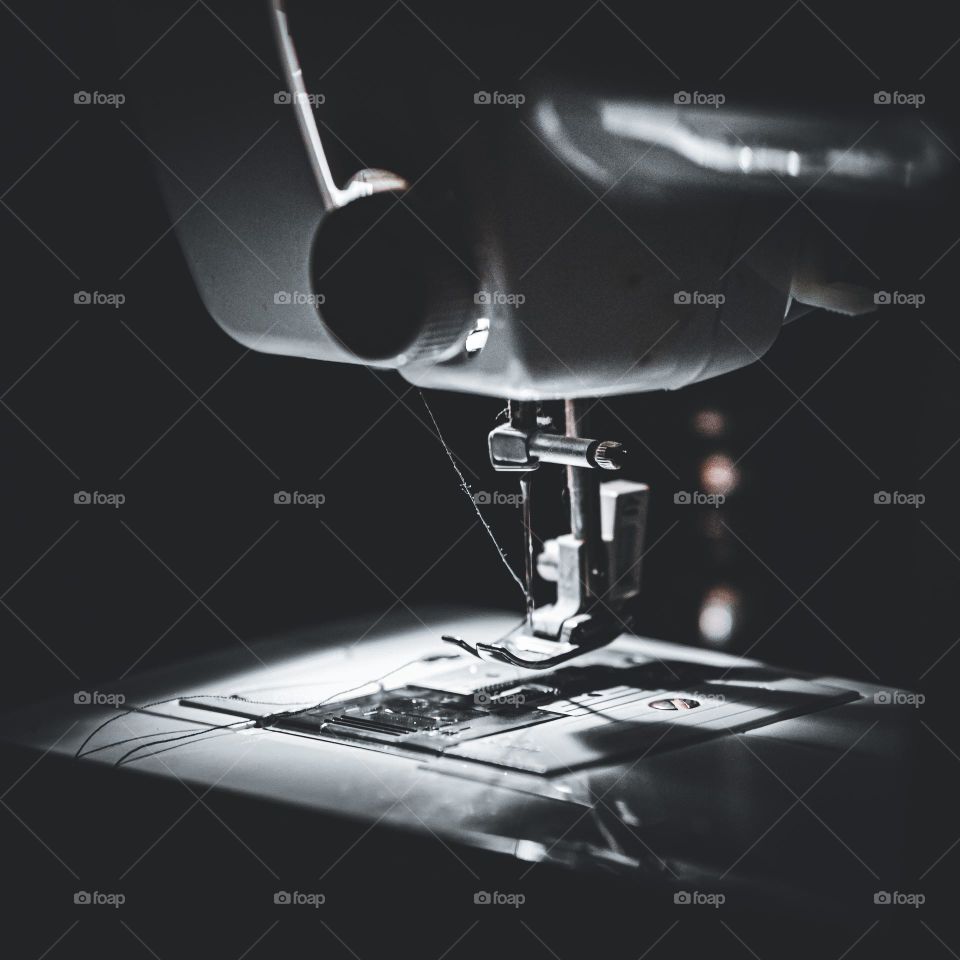 Macro focus of sewing in the dark