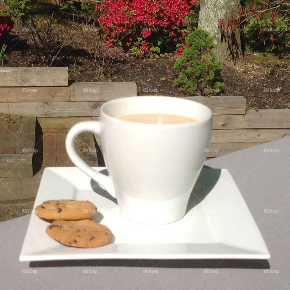 Enjoying a cup of coffee outdoors on a beautiful spring day.